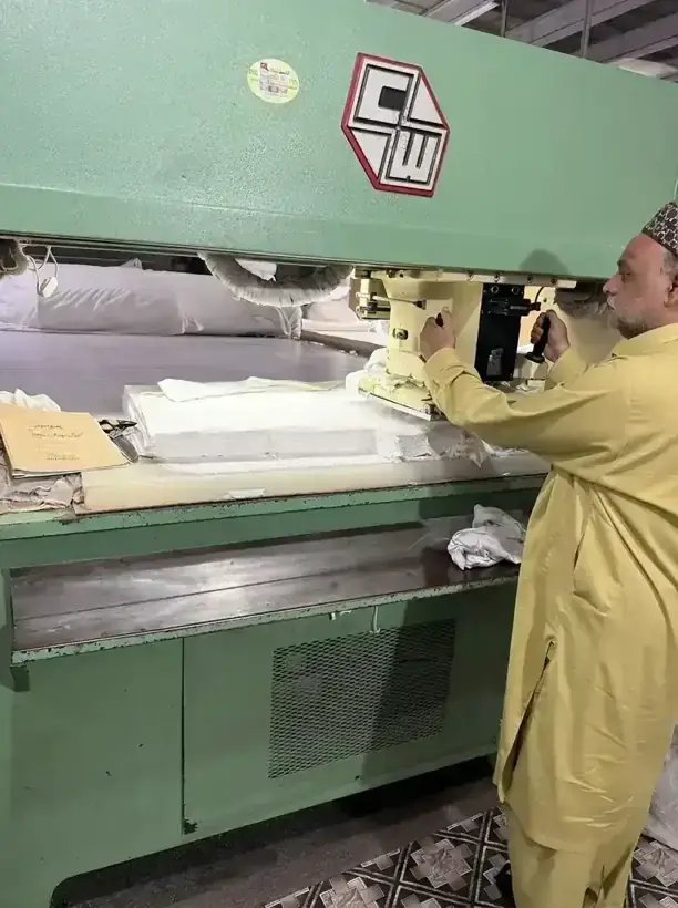 Hydraulic die-cutting press shaping cotton glove panels at SAS Agencies