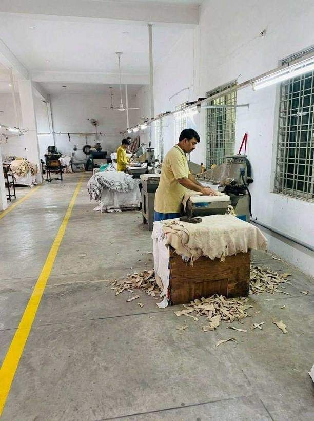 Hide cutting station at SAS Agencies where leather hides are clicked into glove panels by hand