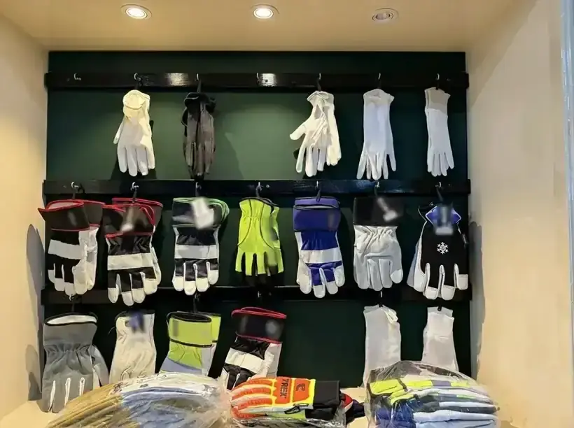 Wall display of cotton dress gloves and insulated winter gloves at the SAS Agencies showroom
